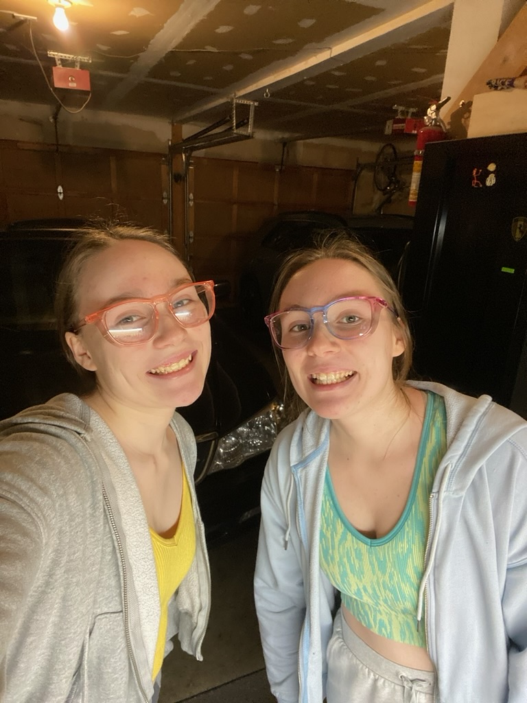 A set of twins wearing colorful safety glasses.